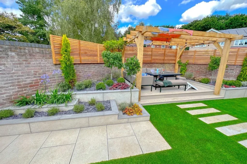 Beige porcelain patio and rendered raised beds with an artificial lawn and stepping stones