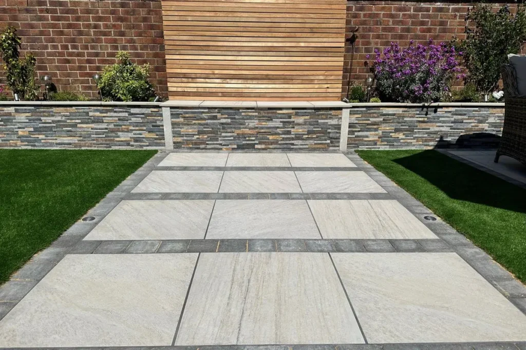 Porcelain path with charcoal banding between artificial grass