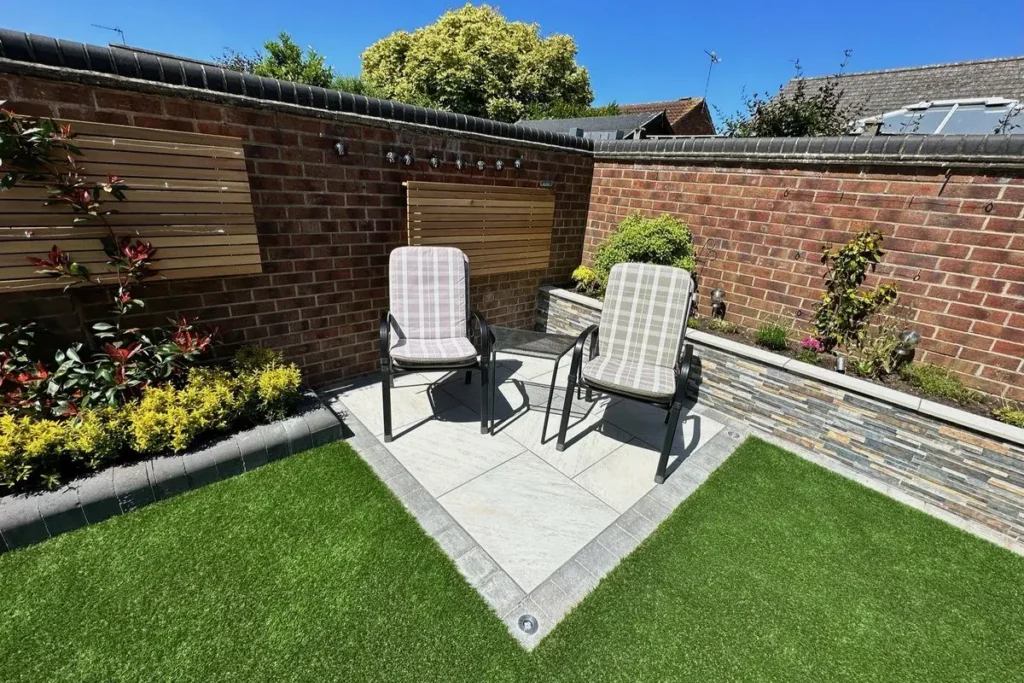 Two recliners on a porcelain square set into artificial grass