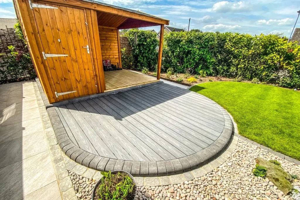 Timber summerhouse with an open canopy on a curved grey composite deck