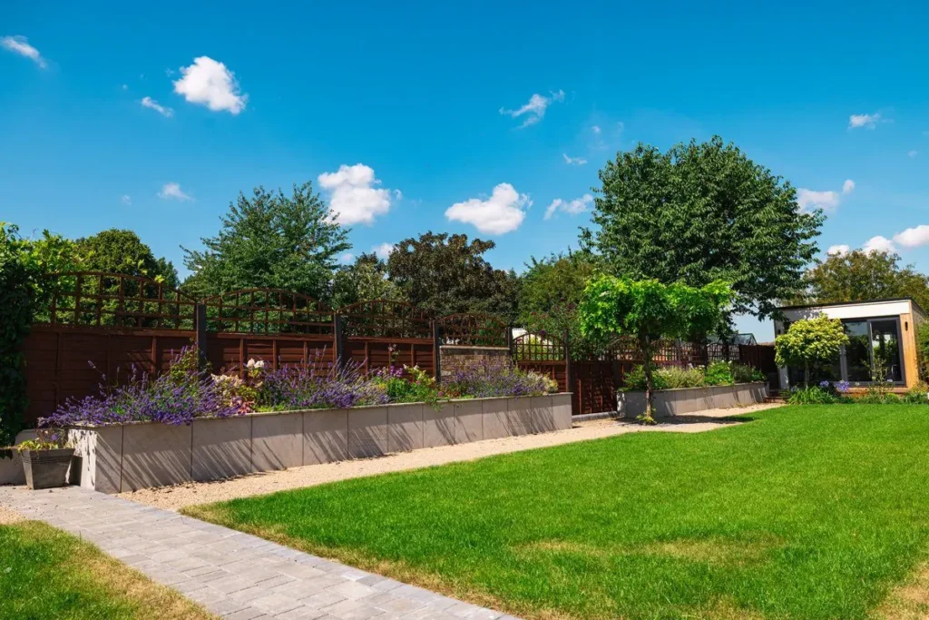 Porcelain-clad raised beds of lavender along a lattice-topped fence